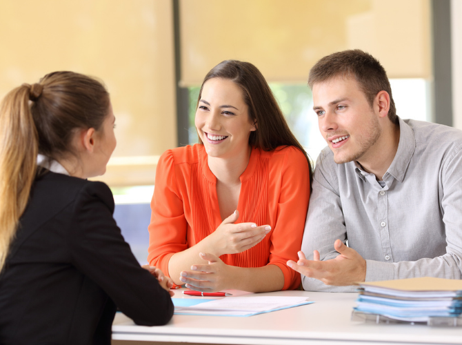 A couple meeting with a legal professional